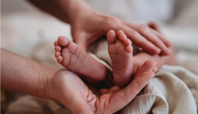 Mother massaging babys legs