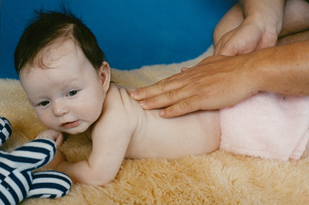 Baby girl enjoys back massage