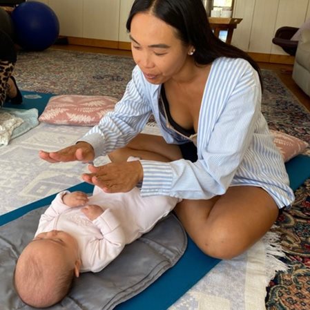 Parent and baby engaging in a responsive, family-centred infant massage interaction