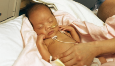 Preterm infant receiving baby massage