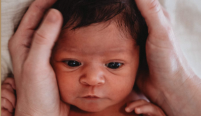 Premature infant receiving baby massage